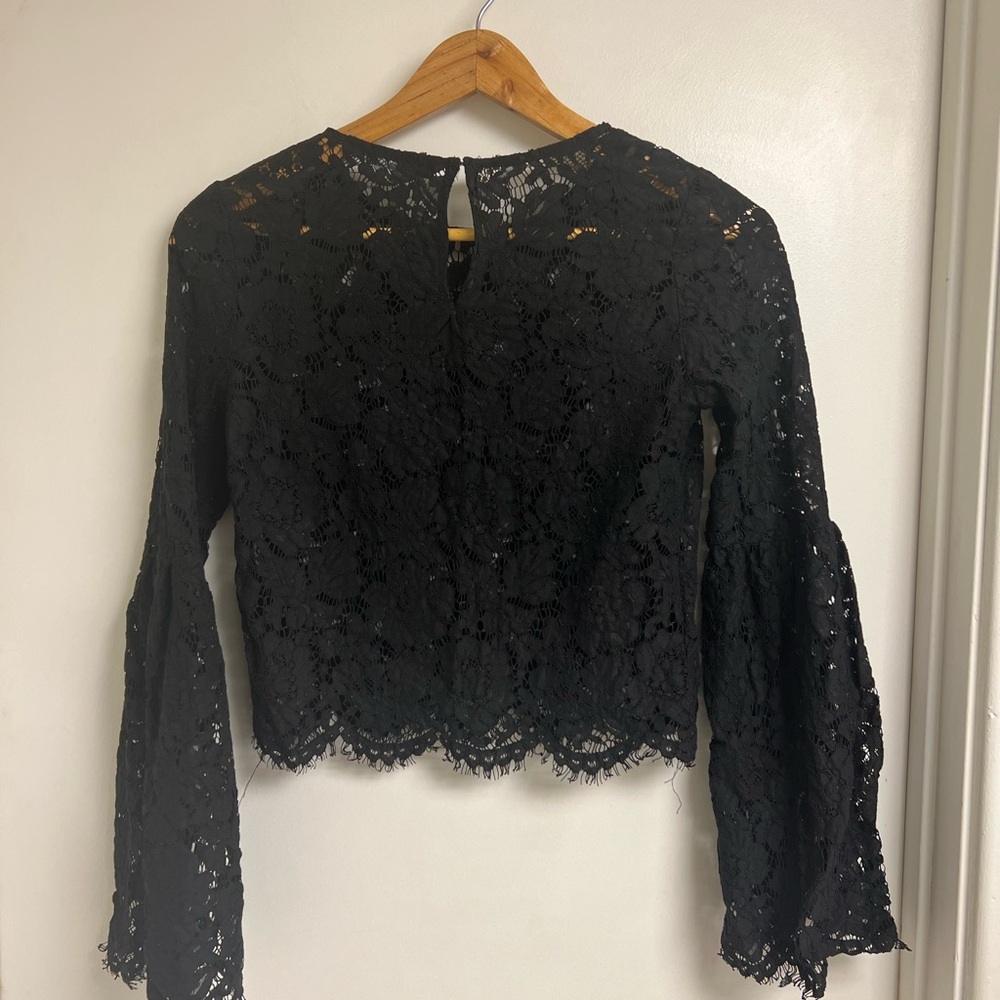 Cropped black lace top with bell sleeves